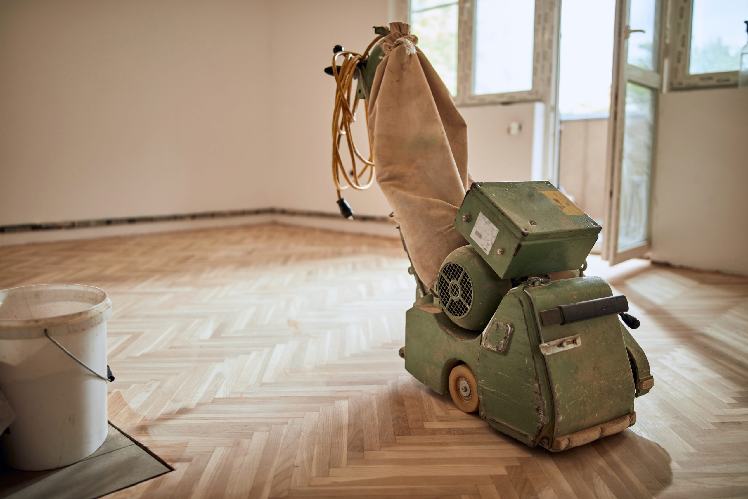 Parquet Floor Sanding in Farnborough with a sanding machine on a newly sanded oak herringbone parquet hardwood floor