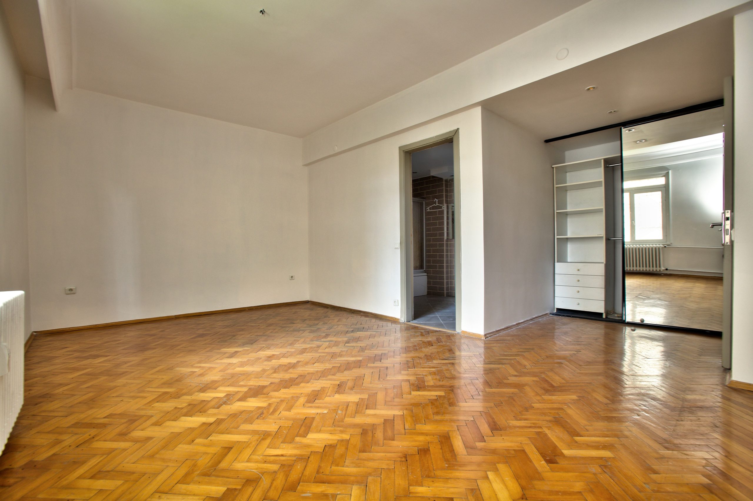 Parquet Floor Sanding in Farnborough on a restored oak herringbone parquet hardwood floor in an empty modern bedroom